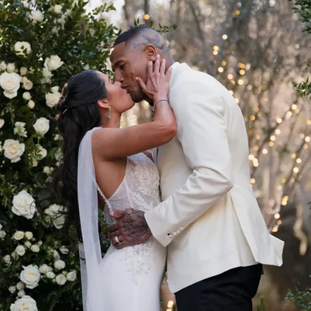 Kelsey Plum kissing her husband after wedding vows