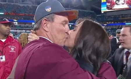 jimbo fisher and courtney harrison fisher kissing in the middle of a big crowd