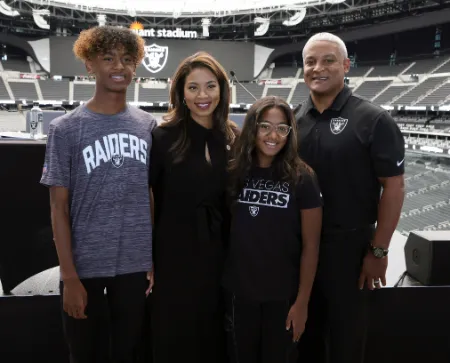 sandra douglass morgan with her husband don morgan and children dylan and dana at a nfl stadium