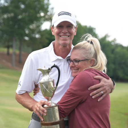 steve stricker with his wife nicki stricker and holding a trophy